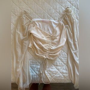 Small, blush top with meshed sleeves